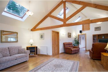 Open plan living space looking towards the bedroom with sofa bed on the left