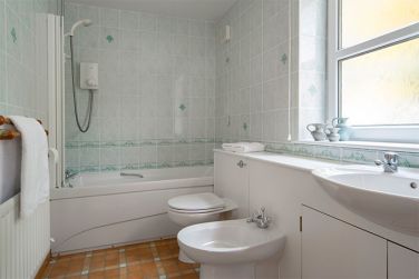 En-suite bathroom/wc with shower over bath- off the large walk-in wardrobe/dressing room  area