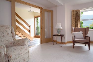 Cocklety How Stable Loft's sitting room and entrance area with stairs