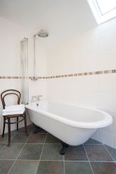 Roll top bath with rainhead shower in Manesty Band