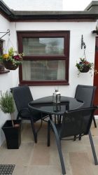 Courtyard with seating, BBQ and utility room with Washer, Dryer, Fridge, Freezer