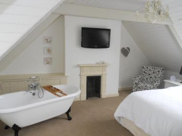 Upstairs Bedrm  King sized bed & roll top Bath and separate WC/Basin upstairs