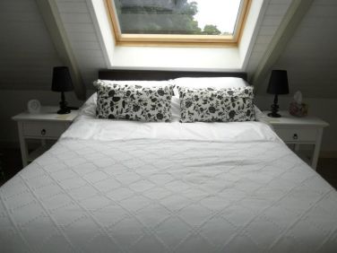 Upstairs bedroom with King sized bed, side tables, hanging space for clothes & drawers