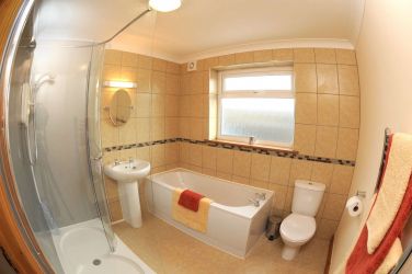 Spacious bathroom with bath and walk-in shower