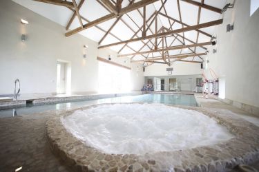 Guests can relax in the Jacuzzi by the pool.