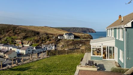 Far reaching views over the village to The Point and Sheep Fields. Taken from the  fire pit terrace.