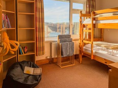Bunk beds. Kids toys and books in the reading nook.