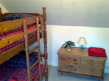 Upstairs bunk room with full sized beds suitable for both children and adult guests
