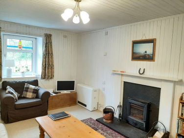 Cosy sitting room with real fire and small TV
