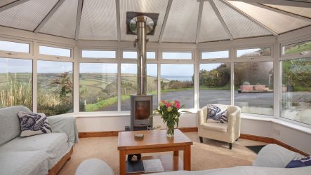Conservatory with wood burning stove and sea views