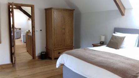 Upstairs bedroom with super king bed/twin with room for for cots