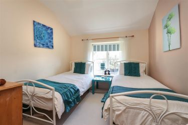 Bedroom 3 with twin beds and space for travel cot