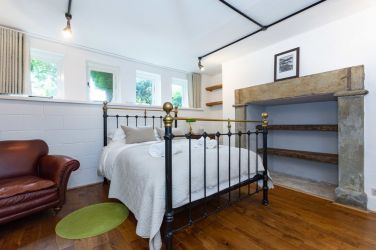 Bedroom 9 Comfy Double bed with metal bedstead and a feature fireplace Fairlea Grange