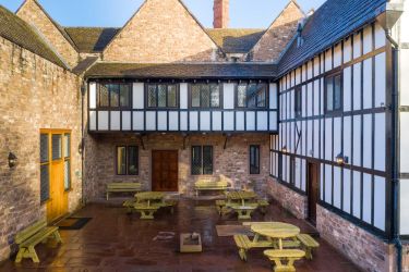 Half timbered building around the patio area The Manor on the Monnow