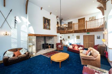 Lounge with the wow factor wood burner fireplace and mistral gallery hallway The Manor on the Monnow
