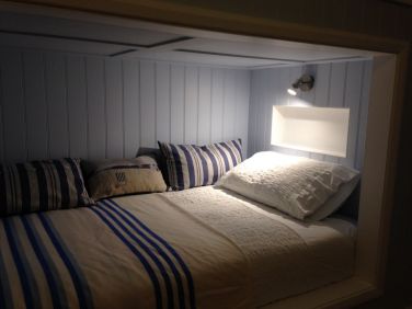 Inside custom bunk, complete with reading light and shelf