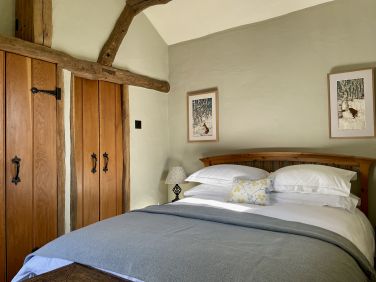 The same bedroom with cupboard (left) and door to the shower room