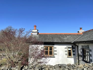 Looking over the wall towards Garden Cottage. And a beautiful blue sky!