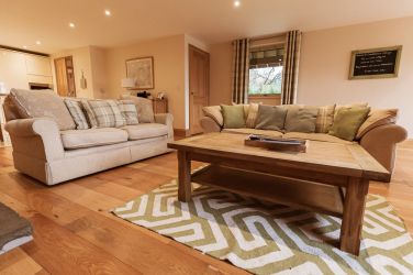 Understairs storage with cusions for outdoor seating, ironing/cleaning items.