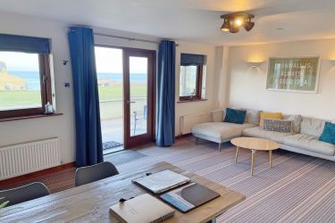 Open plan living & dining space with sea views