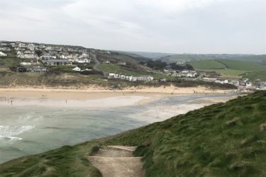 The view of Mawgan Porth and the building from the Coast Path heading towards Watergate Bay