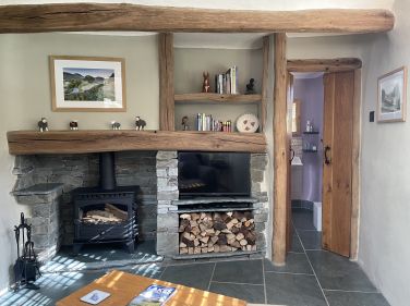 Cosy sitting room with wood burning stove