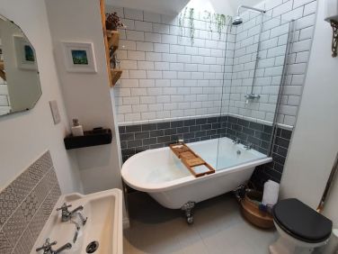 Main bathroom with shower over bath and high level cistern toilet