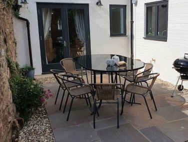 Patio with seating for 8 and BBQ