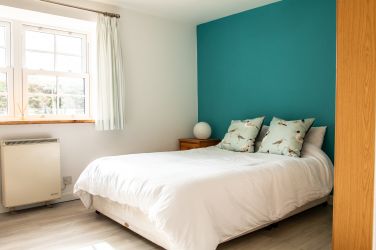 Master bedroom with views over the valley hill tops.