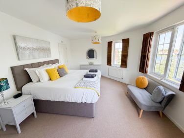 Large master bedroom with lake views and en-suite