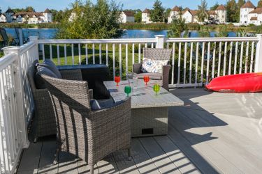 Large deck with seating and tables, perfect to enjoy the lake views
