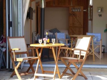 Seated patio area of the Sea Breeze Beach House for Al fresco dining.