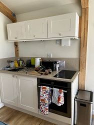 The kitchenette which includes a hob, oven and a small 45 litre capacity fridge.