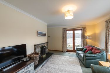 Living room with open fireplace and smart TV