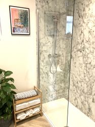 Walk in shower with large rainfall showerhead and power showerhead