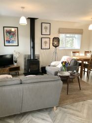 As you enter the cottage the tastefully furnished seating and dining are on your left