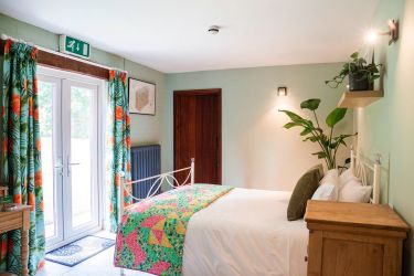 Bedroom 10 GF Double bed with doors on into the garden  Monnow Valley Studios