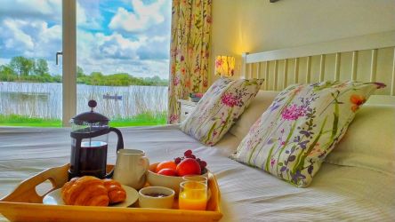 Kingsize ensuite bedroom with wonderful lake views - draw the curtains and watch the sun rise!