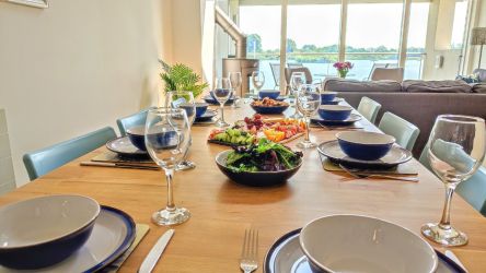 Large oak dining table with wonderful lake views.