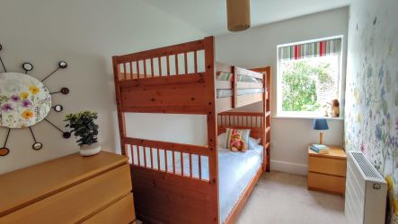 Bunk bedroom with full size sturdy bunk beds.
