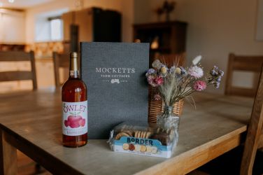 Mocketts Farm Cottages welcome pack with local juice and biscuits