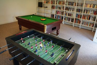 Games room in the outbuildings with pool table and table football - shared use