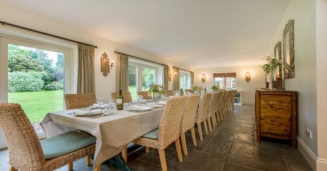 The dining area which can accommodate 18 - 24 people at one long table.  Views over the garden