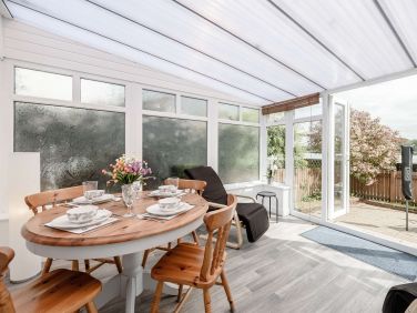 Bright and sunny (we hope) conservatory with its view to the river estuary