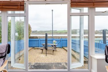 Straight out of the conservatory into the fully enclosed back patio