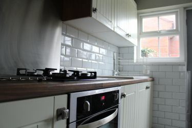 Fully equipped kitchen leading to courtyard garden