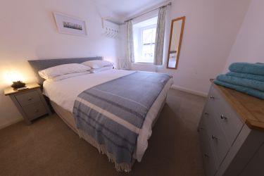 The master bedroom has a king 5' wide double bed.