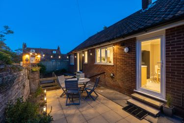 The courtyard is a sun trap by day and beautifully lit space by night