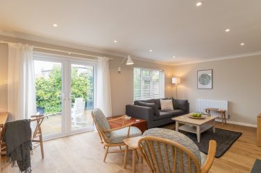 The spacious lounge is a blend of modern and vintage furniture for a relaxed Scandi vibe