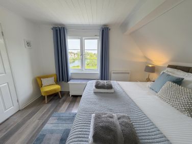 Large master bedroom with en-suite and lake view